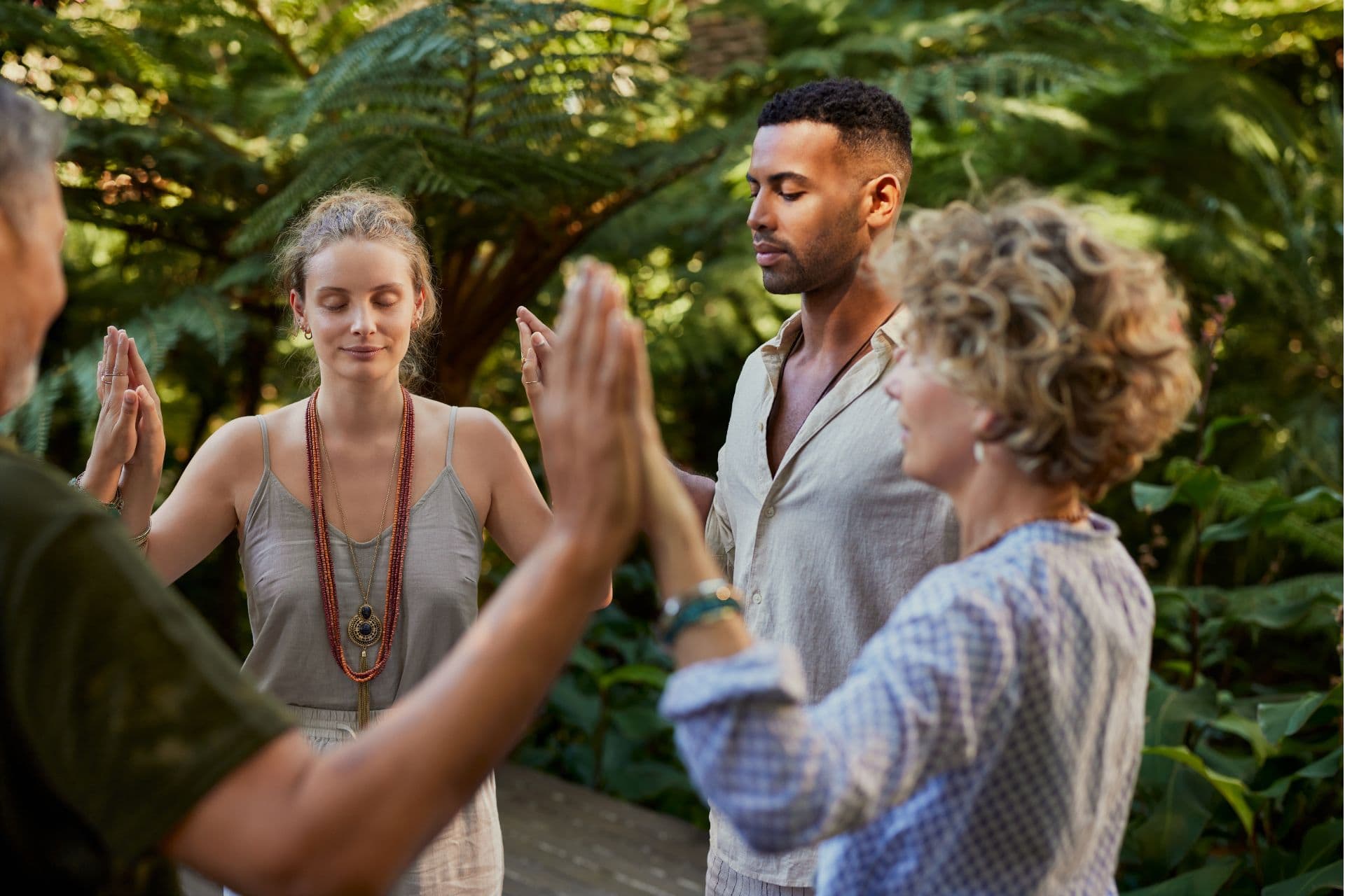 people standing in circle meditation